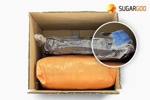 Clothing vacuum sealed inside a shipping box to reduce its volume